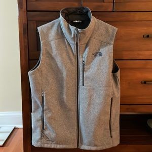 One grey north face vest in great condition